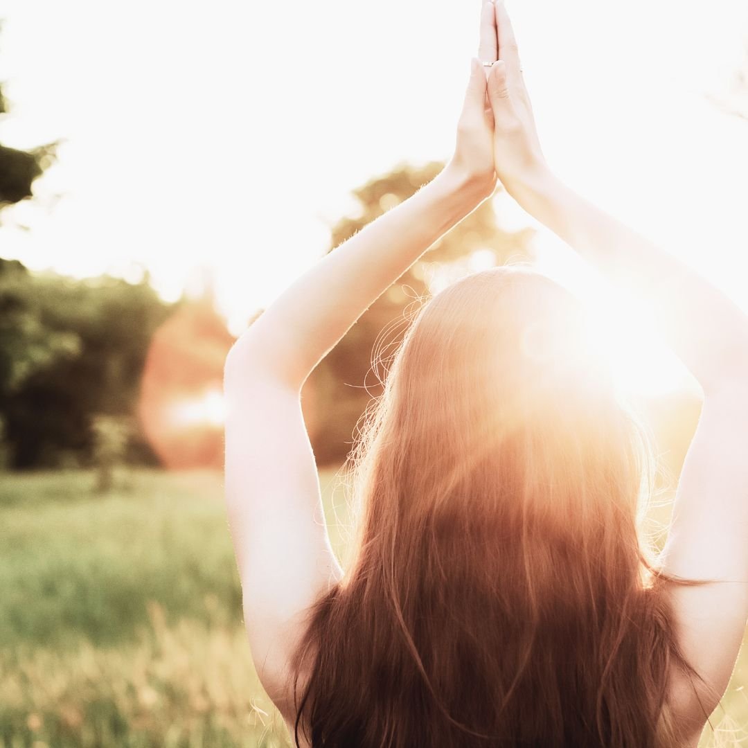 light meditation woman with hands at heart