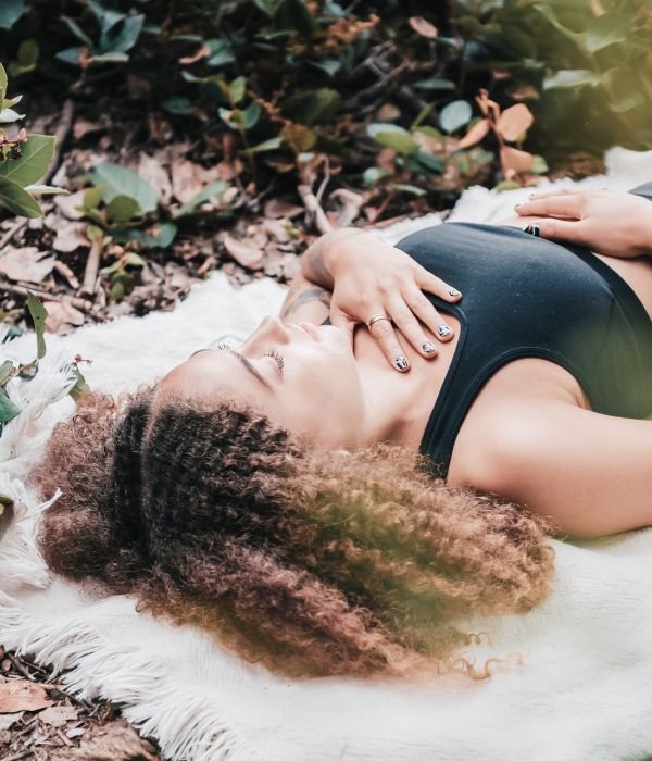 woman lying on the ground meditating
