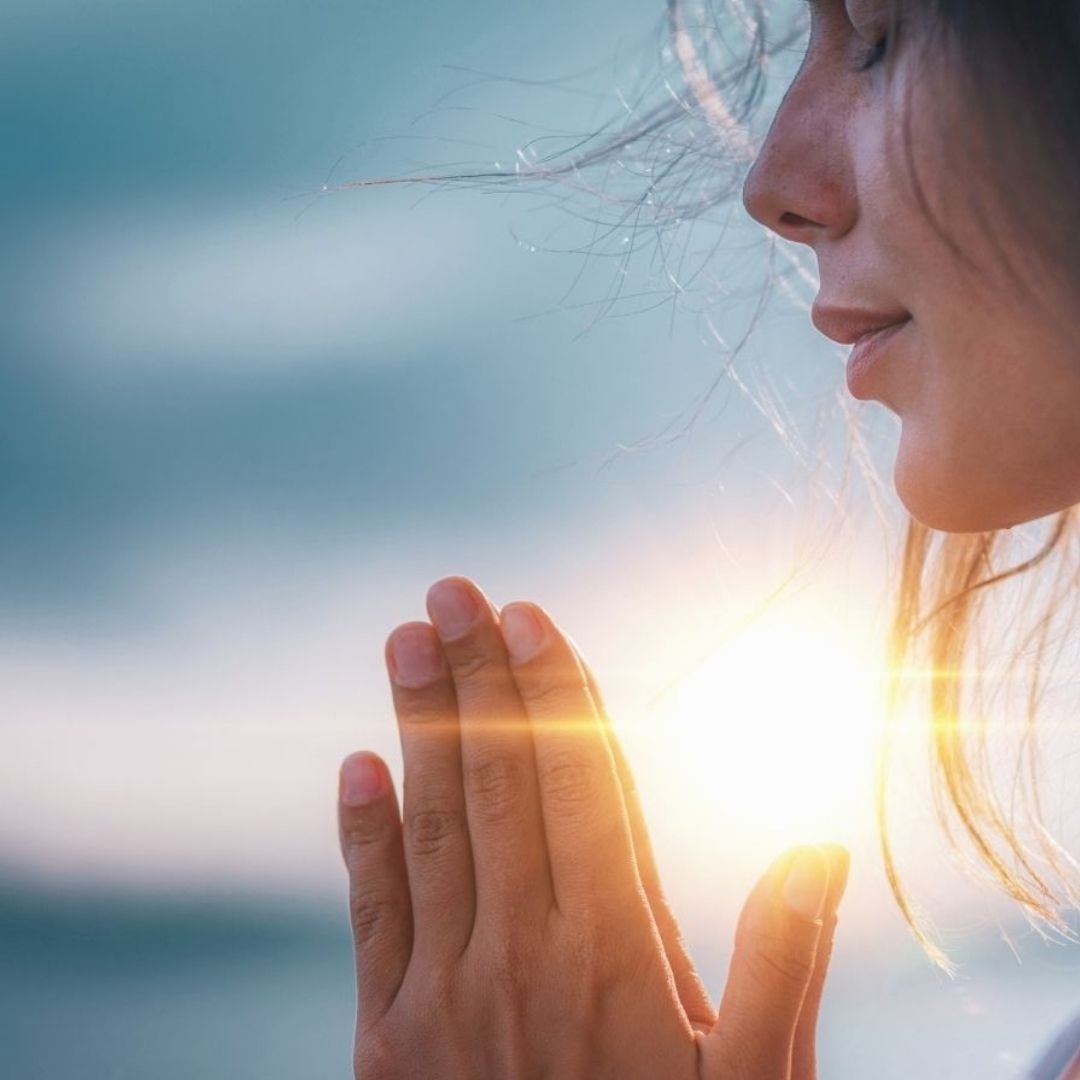 ptm small woman with prayer hands and sun