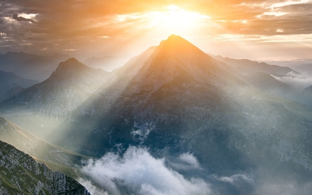 sunlight through clouds on mountains