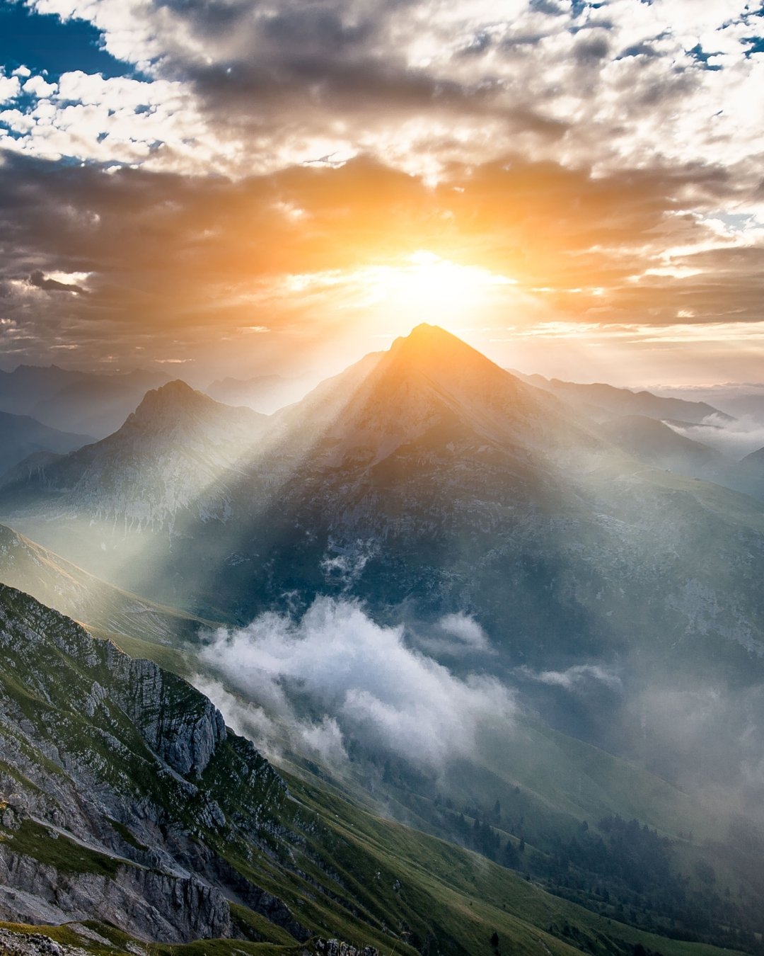 sunlight through clouds on mountains