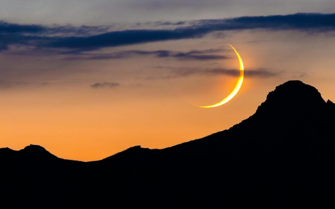 new moon above mountain