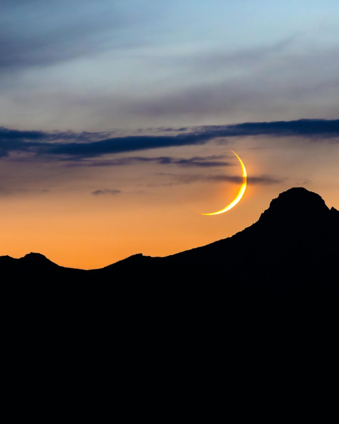 new moon above mountain